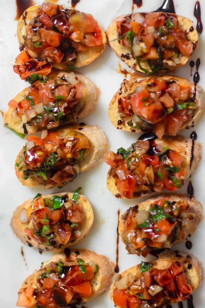 Bruschetta on crostini on a plate.