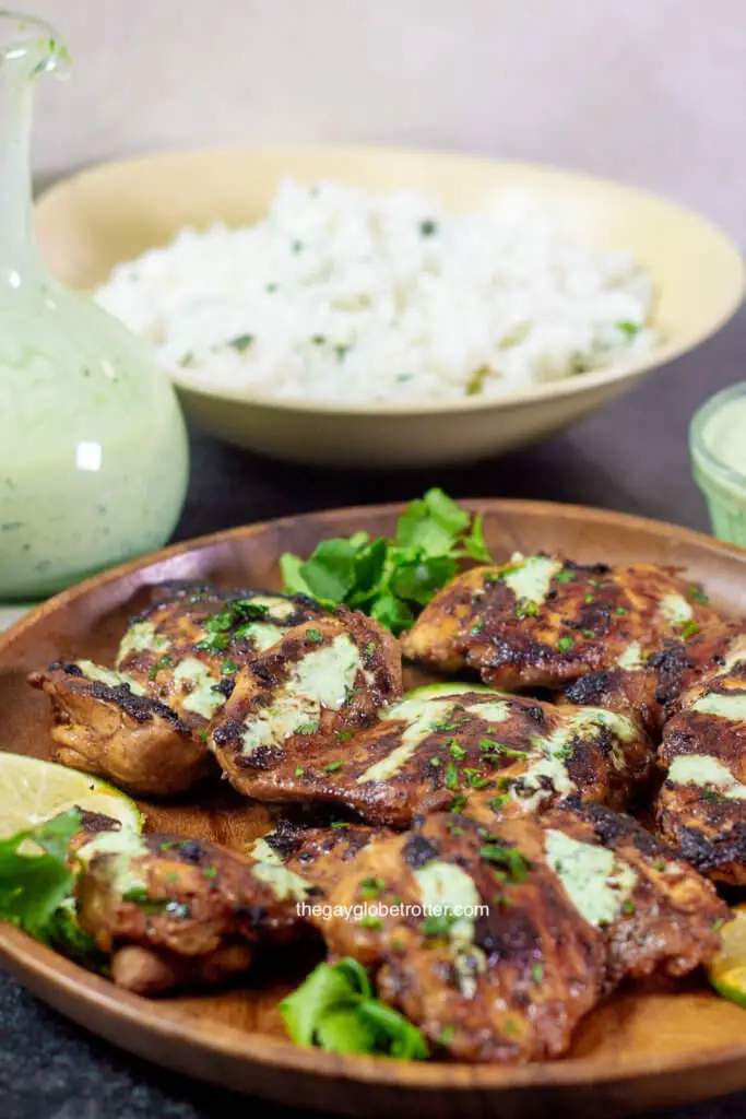 Peruvian chicken (pollo a la brasa) with cilantro lime rice and aji verde ready to be served.