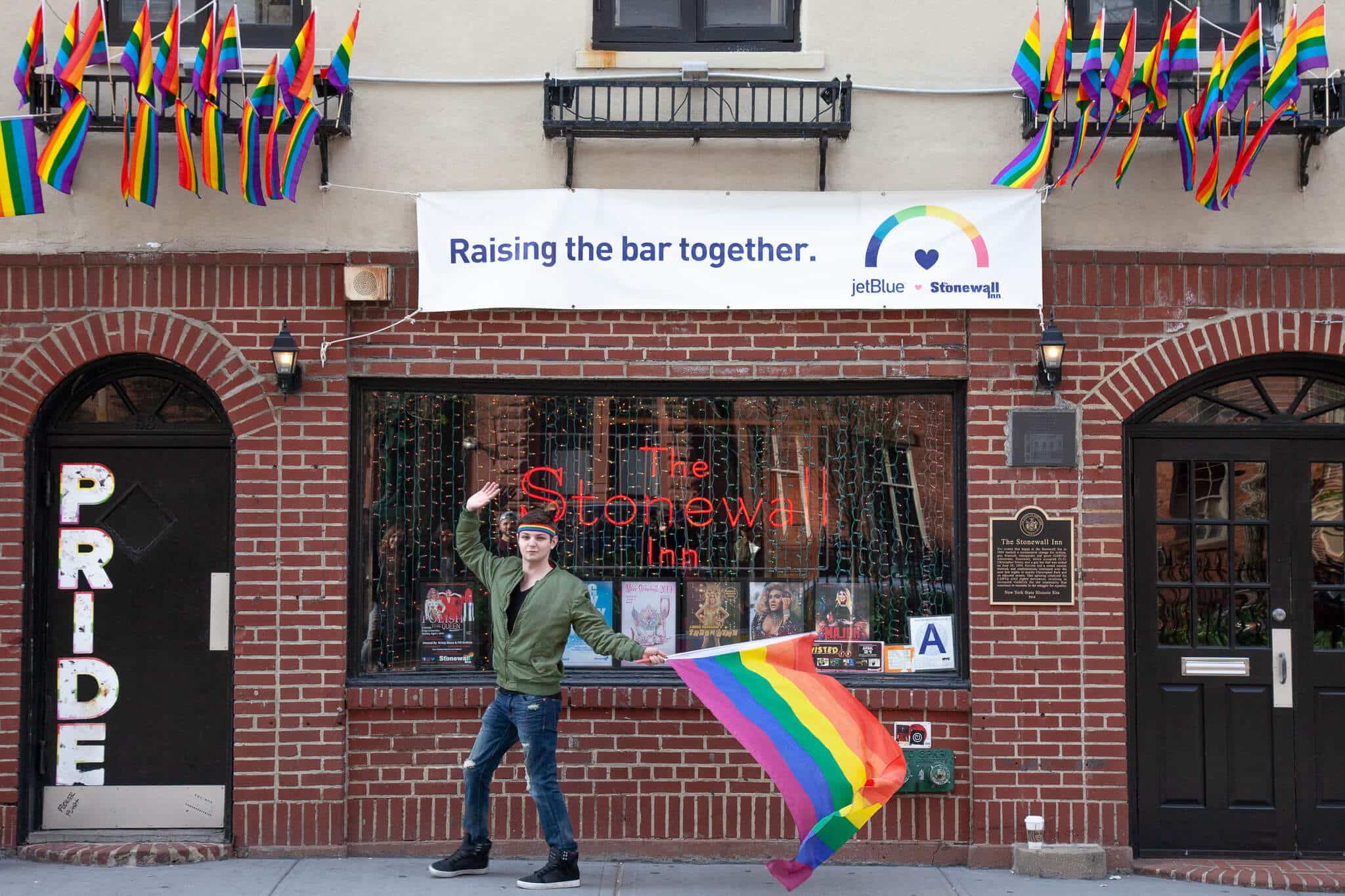 Lgbt Community Gay Club with Rainbow Flag on the Facade of a Brick