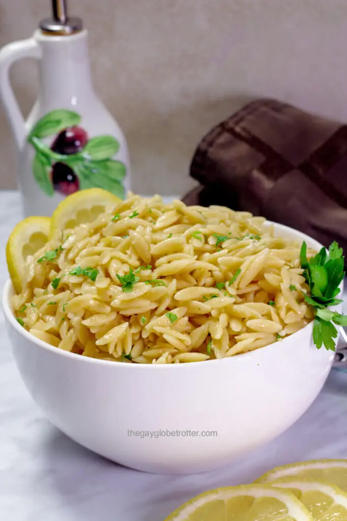 A serving bowl full of lemon parmesan orzo.