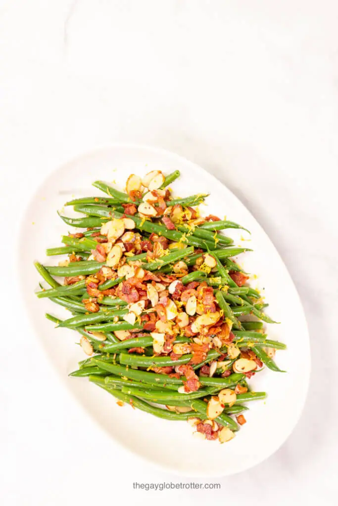 A serving platter full of fresh green beans almondine.