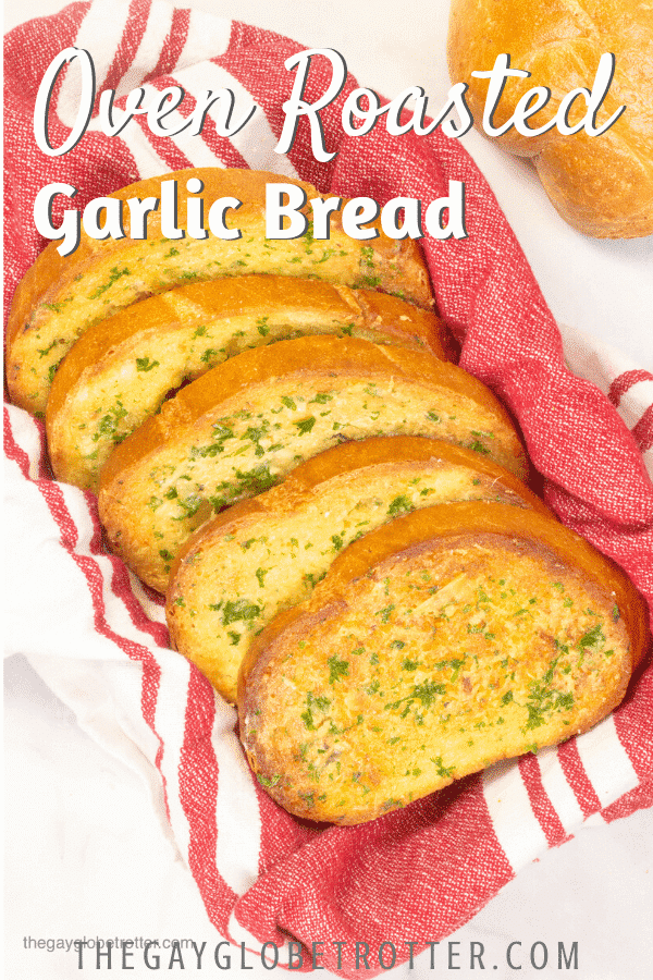 Roasted garlic bread in a basked with text overlay that reads "oven roasted garlic bread."