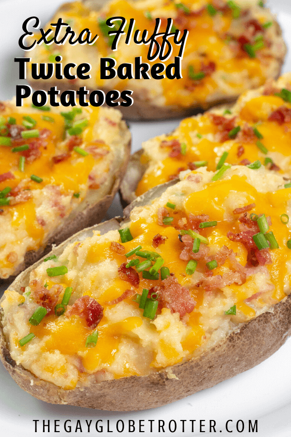 A twice baked potato on a serving platter with text overlay that reads "extra fluffy twice baked potatoes."