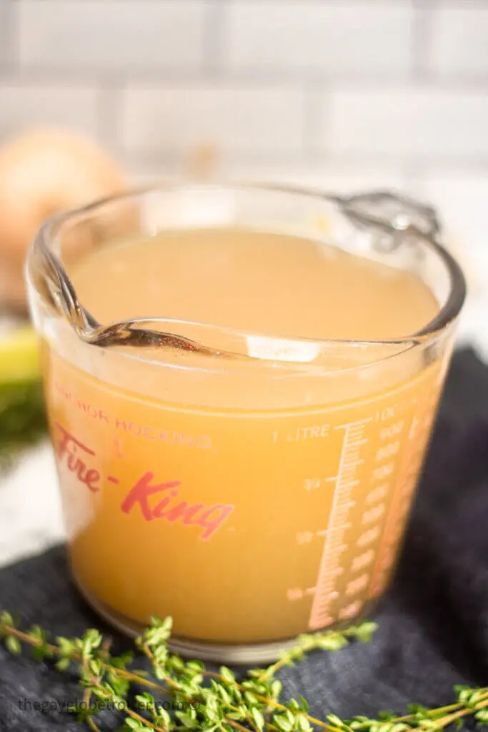 A measuring cup of Instant Pot turkey stock.