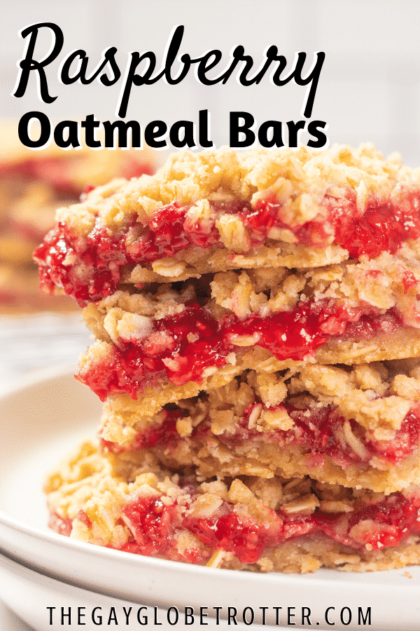 Raspberry oatmeal bars in a stack on a plate.