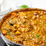 A pot of Guinness stew topped with parsley.