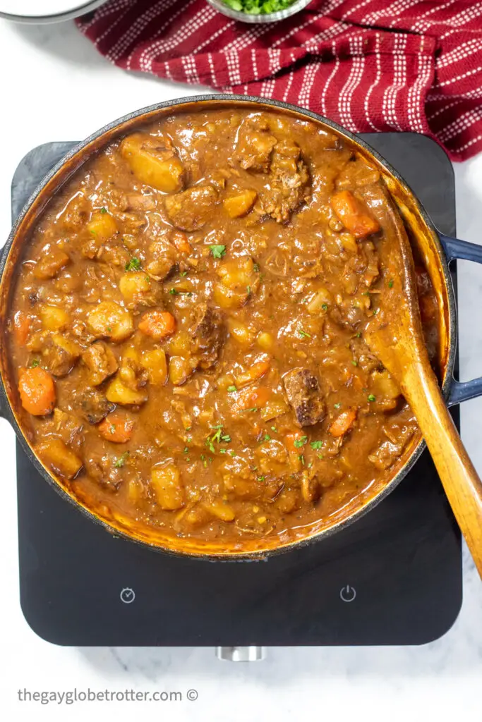 A spoon stirring Irish stew.