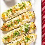 Mexican street corn on a plate with cilantro and chili powder.