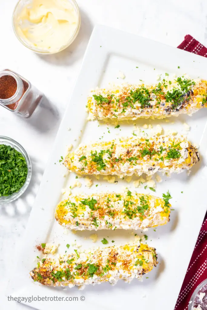 For cobs of mexican street corn on a serving plate.