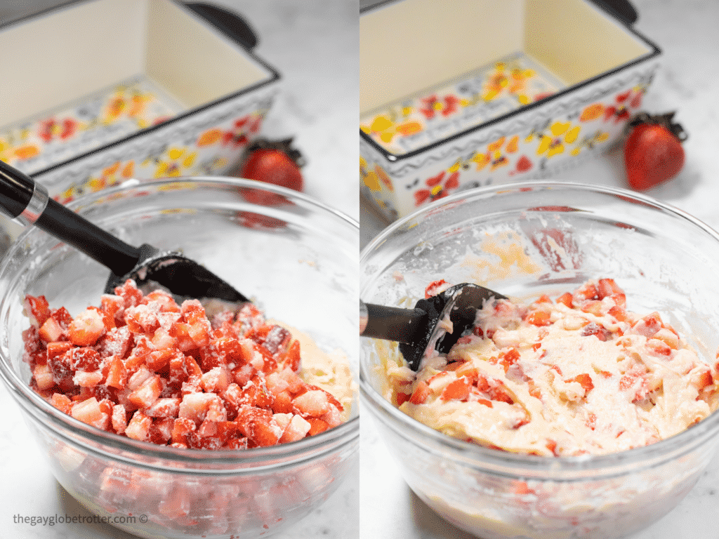 Strawberries being folded into bread batter with a spatula.