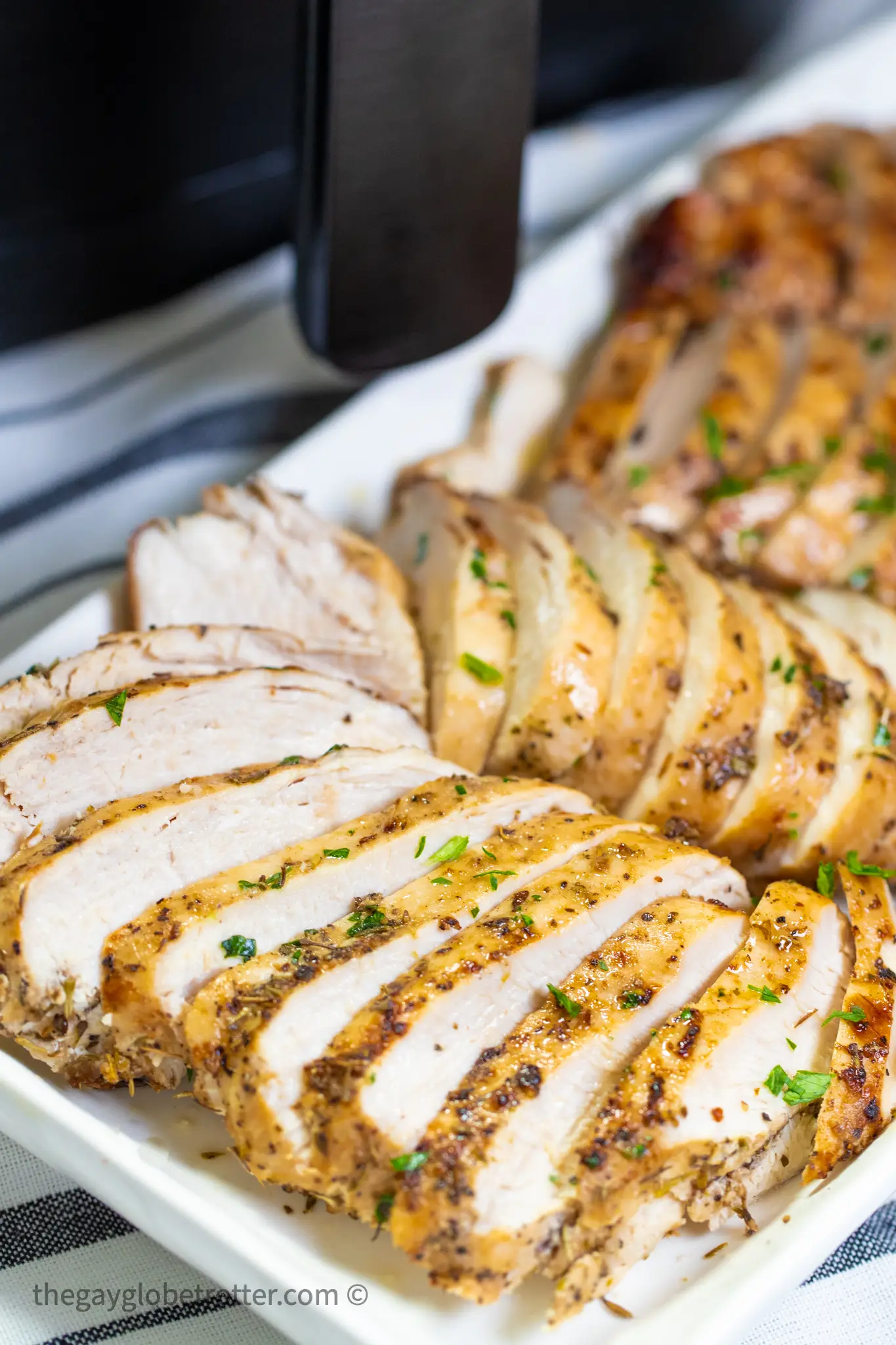 Chicken breast sliced on a serving tray.