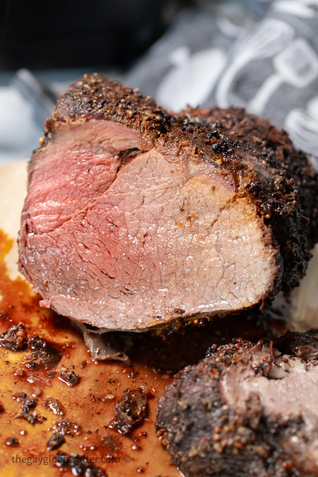 Air fryer roast beef on a cutting board.