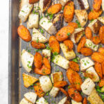 A baking sheet with roasted turnips and carrots.