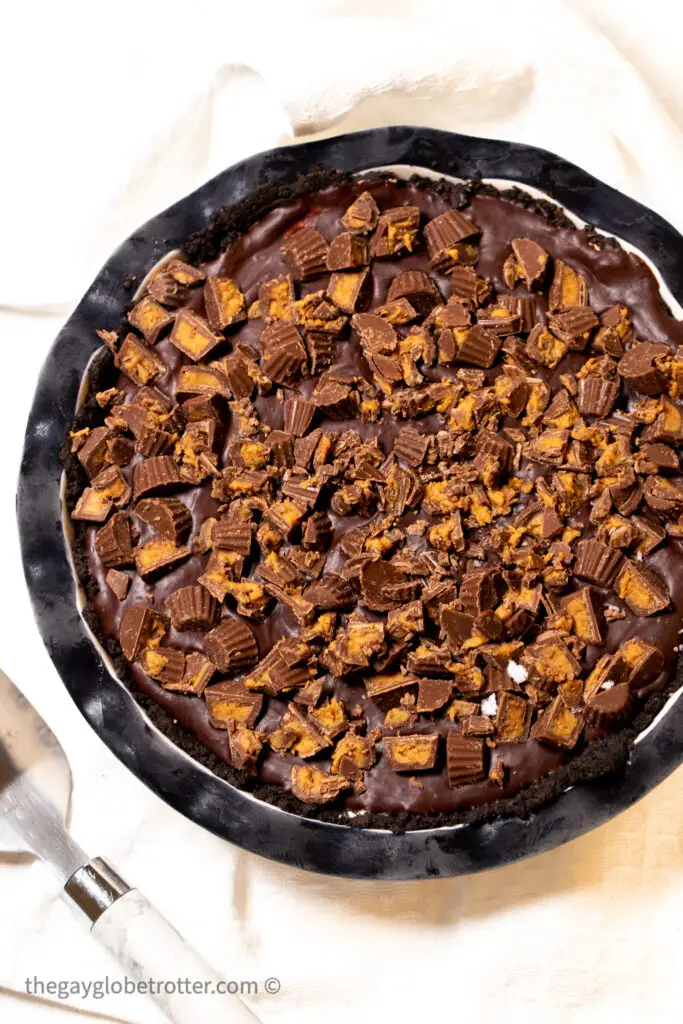 Chocolate peanut butter pie next to a pie server.